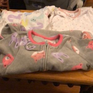 Three pairs of zipped footed pjs